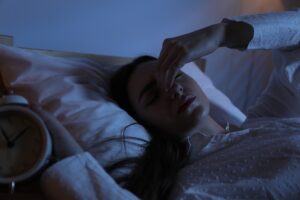 Person awake in bed in the early morning hours, illustrating the 3 AM wake-up pattern that B-vitamins can contribute to