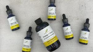 Herb-Science individual liquid B-vitamin bottles arranged with the B-Complex bottle, illustrating the choice between targeted single B-vitamins and full B-complex supplementation.